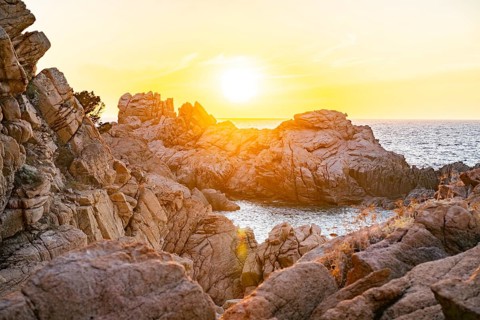 Landscape of the coastline with blue water at Costa Paradiso on a sunny day at sunset, Sardinia,