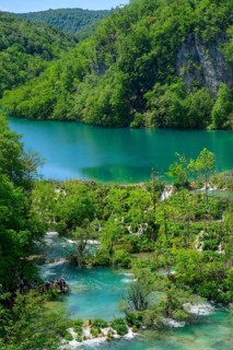 A high view of tourists viewing the waterfalls at Plitvice Lakes National Park, Croatia