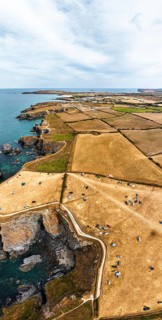Panorama of Farms and Fields over Cliffs and Porthcothan Bay from a drone, Porthcothan, Padstow,