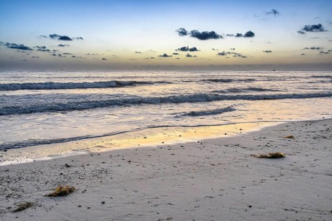 Waves roll in at sunset on Poche Beach, San Clemente, California, United States