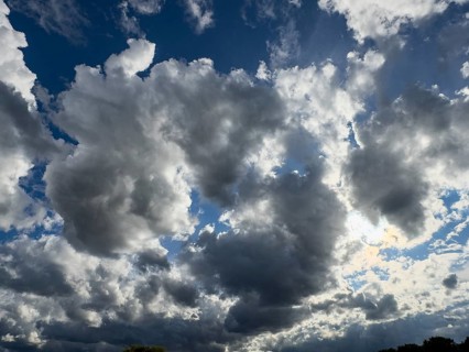Large cloud field of dark cumulus cluster clouds at the bottom announce rain rain front,