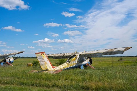 Disintegrated aircraft on a wide field under a slightly cloudy sky, multi-purpose aircraft evom