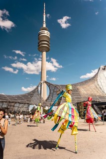 Artist of the zebra stilt show in front of the Olympic Tower at the Superbloom Festival in Munich's