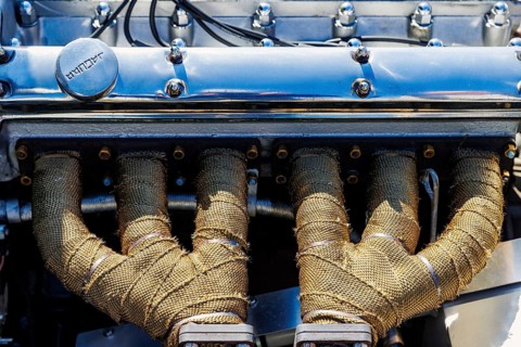 Exhaust manifolds wrapped in heat tape on a classic Jaguar XK straight-six engine