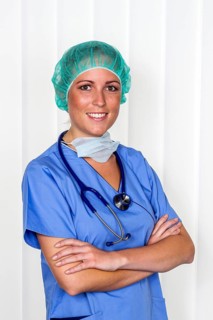 A nurse or doctor, female doctor, in surgical clothing in front of an operation. Symbolic photo for