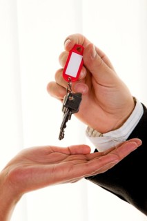 Successful real estate agent hands over the key to an apartment to a woman, realtor, landlord,