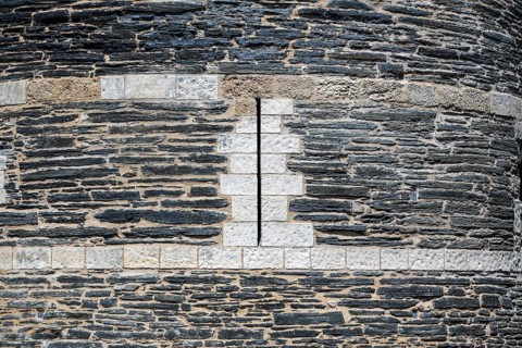 Detailed view of one of the mighty defensive towers with narrow, vertical loopholes, built of slate