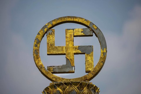 Golden swastika symbol in traditional Buddhist form, symbol of luck, protection and the cosmic