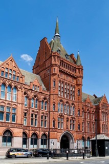 The red terracotta tower and fleche of Holborn Bars rise above High Holborn, part of Alfred