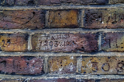 Secret London. The initials TK and the year 1913 are carved into a brick along Myddelton Passage in