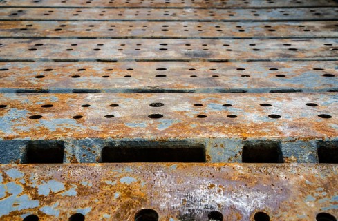 Detail of the crawler steel tracks a lattice boom crawler crane at a construction site of the wind