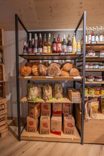 Large shelf with breads, juice bottles and juice cartons in a grocery store, baking bread,