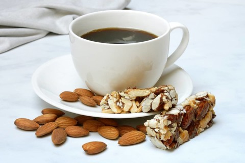 Nut bar and cup of coffee, protein bar