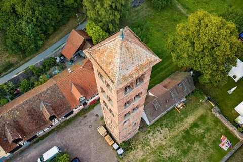 Bird's-eye view of rural tower surrounded by historic buildings and green areas, Calwer