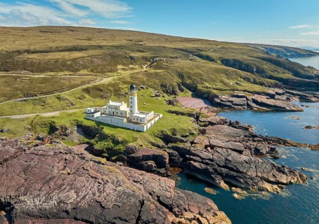 Aerial photo of the lighthouse on the rocky red cliffs of Rua Reidh point, Gairloch, Scotland, UK