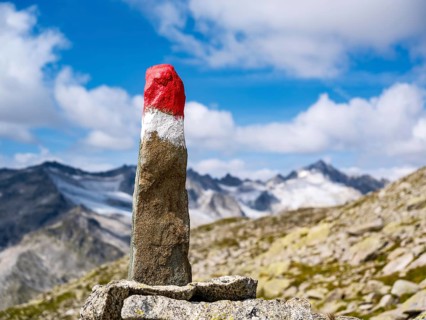 Spitzer Stein as a trail marker, glaciated mountains behind, Venice Group, Hohe Tauern National