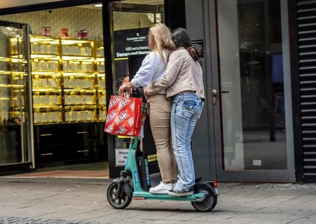 E-scooter in the city center of Essen, people ride in pairs on the electric scooter, is prohibited,