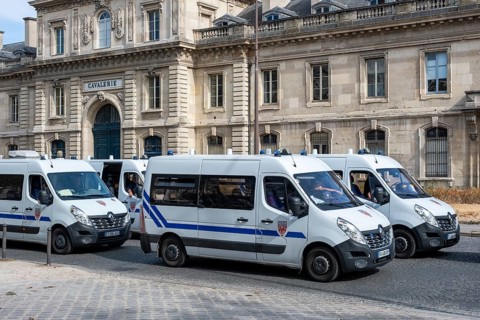 Several white Renault Master Police National vans secure a demonstration in the urban area, Paris,