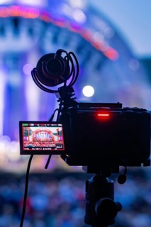 Camera with microphone films a colorful concert stage during a live stream, Calwer Klostersommer