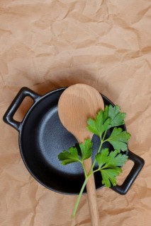 Parsley and cooking spoon on pot
