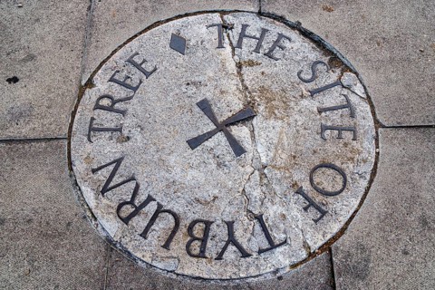 Secret London, Weathered stone plaque set into the pavement marking the historic Tyburn Tree