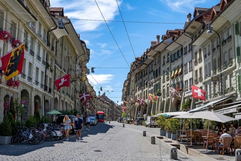 Gerechtigkeitsgasse with historic houses decorated with Swiss flags, old town, Bern, Canton of