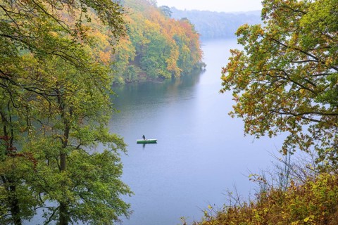 Canoeists on autumnal Schmale Luzin, lake in Mecklenburg-Western Pomerania, Feldberger