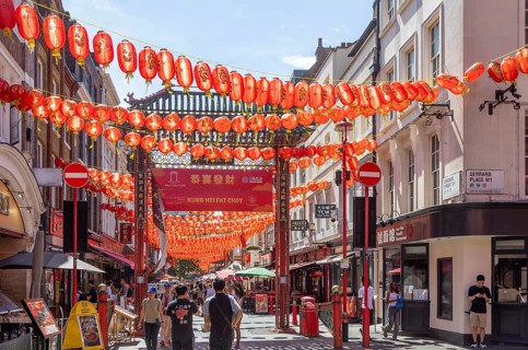 Red Chinese lanterns suspended over street in Chinatown, Gerard Street, Soho, London, England, UK