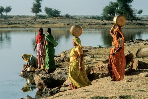 Women carry stuffed water balls on their heads at Gadsisar Lake, Jaisalmer, Rajastan, India