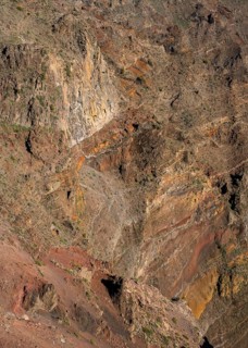 Different rock layers and layers of lava in yellow, orange, ochre and red in the Caldera de
