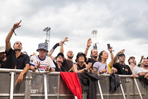 Festival visitors celebrate in the front row at the Klassentreffen Festival on the Central