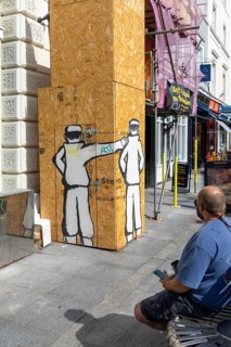 The Holdings Hooligan street art temporary plywood building hoarding, Queen Street, Exeter, Devon,