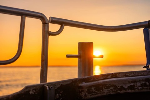 Sunset light shines through a boat railing, Howth, Ireland