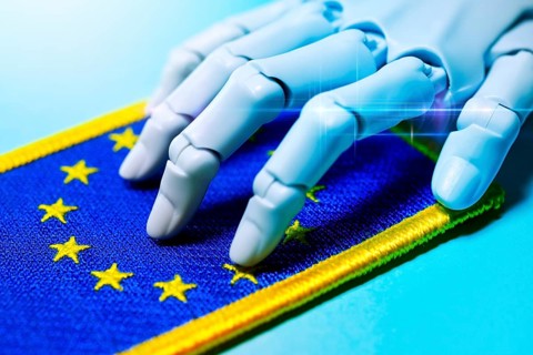 Robot hand on EU flag, AI laws and AI guidelines, photo montage +++ editorial use only
