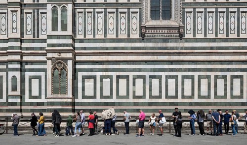 Mass tourism, overtourism, waiting in front of Santa Maria del Fiore Cathedral, Duomo by Filippo