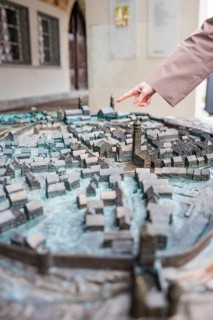 Hand points at a detailed city model with many buildings, Isny, Allgäu, Bavaria, Germany
