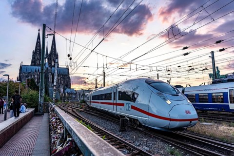 The Hohenzollern Bridge across the Rhine, railway bridge, ICE train leaves the main station, heads
