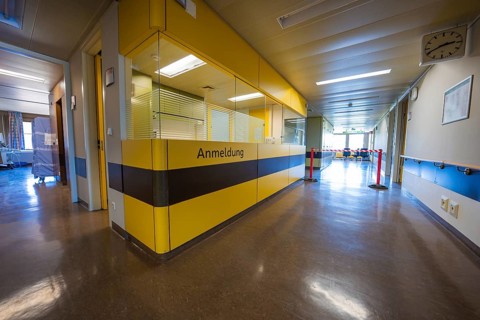 Reception area with yellow reception in a hospital corridor, Nagold Hospital of the Southwest