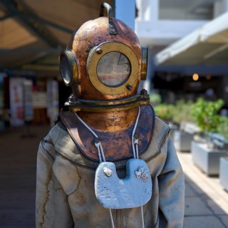 Antique diving suit with copper helmet in an exhibition, Pothia, main town, port, Kalymnos, Sponge