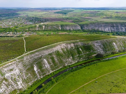 Rising hill ranges surrounding a river in a green agricultural region, aerial view, landscape on