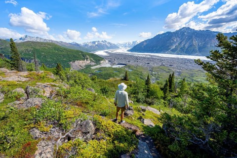 Young man enjoying the view, view of impressive mountain landscape with Matanuska glacier and