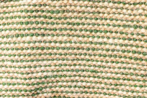A close-up view of a woven fabric with alternating green and beige stripes. The texture is soft and
