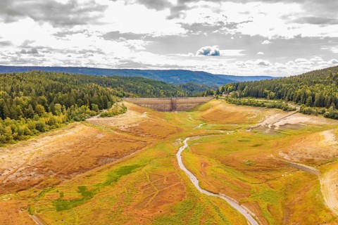 An extensive view over a valley with dam and meandering river, rehabilitation of the Schwarzenbach