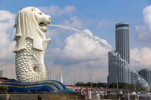 Iconic Merlion fountain spouting water designed with a lion head and fish body at Merlion Park
