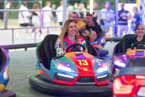 Visitors ride bumper cars at the Klassentreffen Festival on the Central Fairground in Berlin on 29
