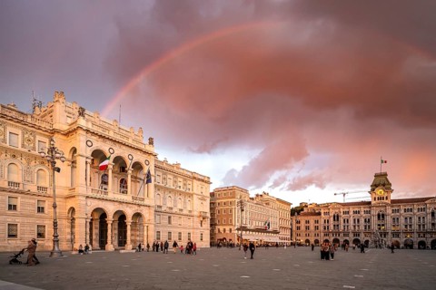 Piazza Unità d'Italia square with town hall and magnificent palazzi in the evening light at sunset