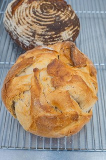 Two loaves of bread with crispy crust on a metal rack, baking bread, Haselstaller Hof, Gechingen,