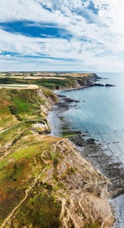 Panorama of Cliffs and Fields over Welcombe Mouth Beach from a drone, North Devon and Cornwall