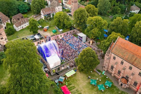 Large festival in a historic area with many visitors in daylight, Calwer Klostersommer Festival,