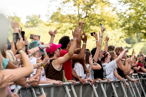 Festival visitors celebrate in front of the stage at the Superbloom Festival in Munich's Olympic